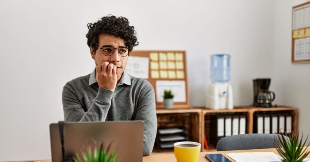 Male Biting Nails At Computer, Concept Of Proactive Steps To Avoid Tooth Decay