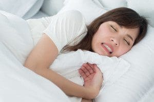 The Damaging Side Effects Of Teeth Grinding And Clenching Clenching Stressed Woman With Grinding Teeth, Bruxism Symptoms; Portrait Of Stressful, Exhausted, Tired Sleeping Woman Grinding Her Teeth With Stress; Oral, Dental Care Medical Concept; Asian Adult Woman Model