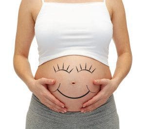 Close Up Of Pregnant Woman Touching Her Bare Tummy