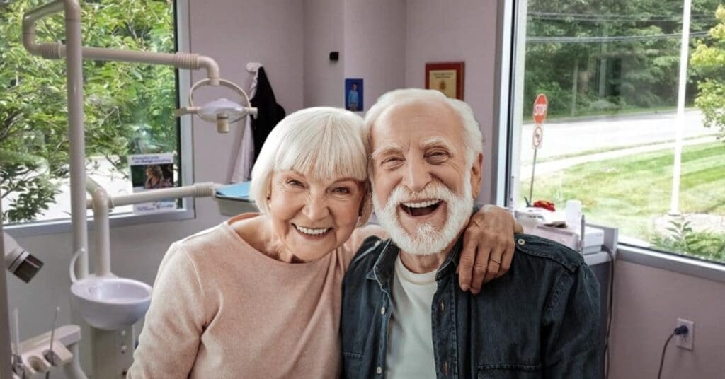 Elderly Couple Smiling In Dental Office