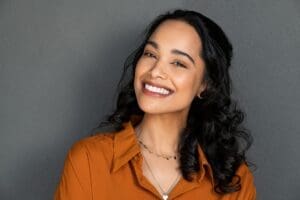 a woman smiling showing her teeth