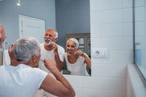 older couple brushing teeth concept Oral Care For the Elderly