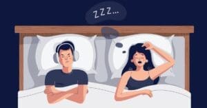 girl sleeping in bed with head on pillow and man with head phones on ears