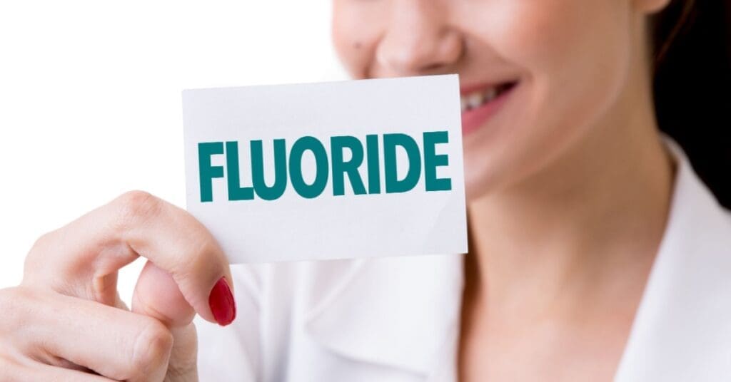 Woman Holding A Fluoride Sign
