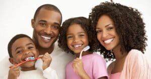 African American family brushing their teeth, concept of oral care steps to promote better dental health