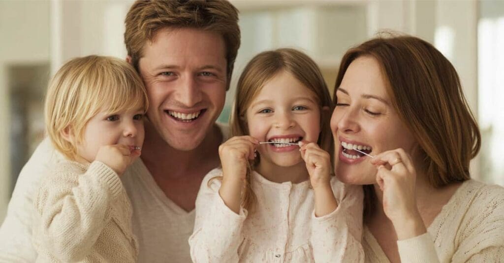 Make Flossing A Fun Family Activity Family Activity Family Flossing Their Teeth, Concept Of How To Make Flossing A Fun Family Activity